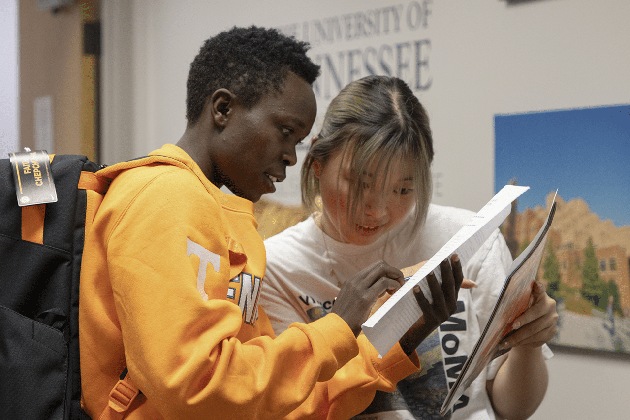 Two students look at documents.